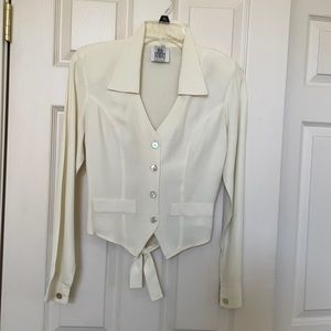 Cream colored formfitting blouse long sleeves.